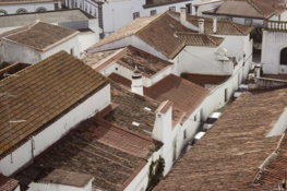an-aerial-view-of-a-city-with-rooftops-and-buildings.jpg An aerial view of a city with rooftops and buildings